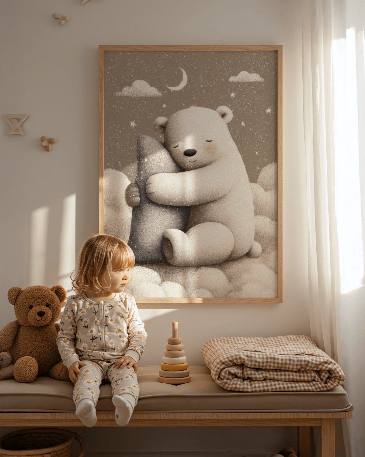 Print on a wall in a nursery of a polar bear hugging a grey pillow with stars and moon