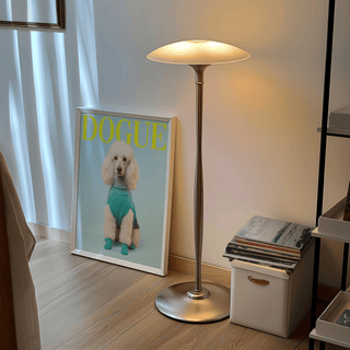 Pet Wall Decor print leaning on floor by a modern floor lamp and a box with books