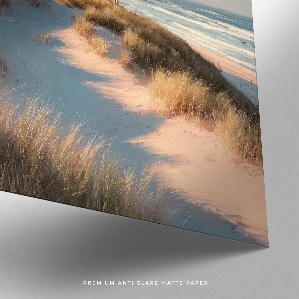Detail close-up of photographic lighthouse wall art showing sand dunes and grasses in soft natural colours