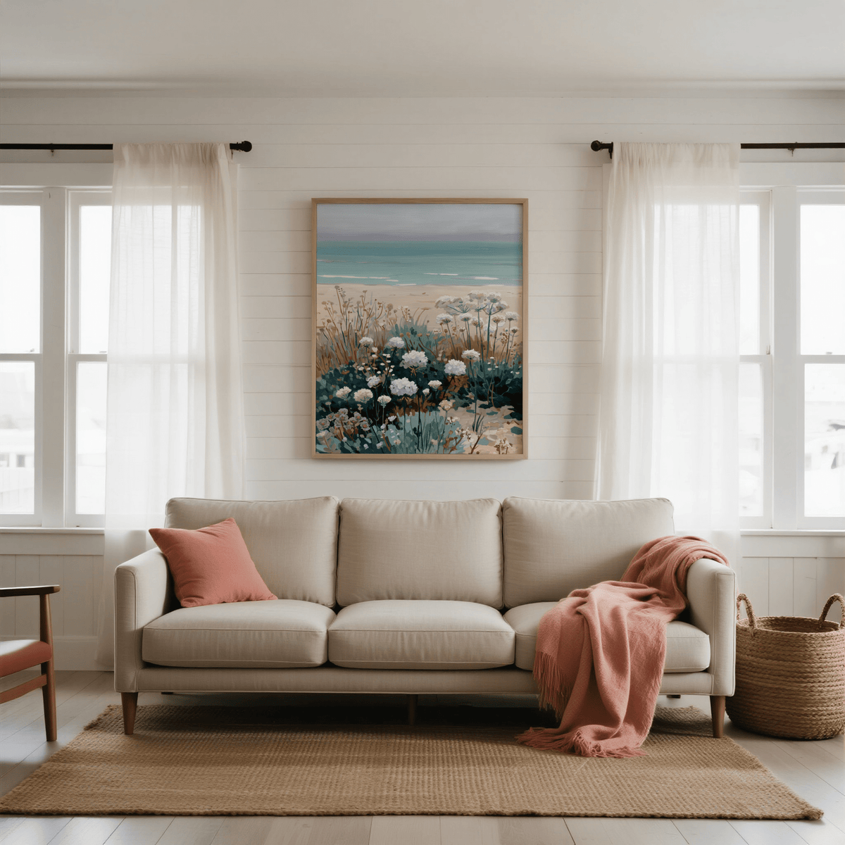 Beach Floral Art print on a white wall above a beige sofa with coral cushion and throw in a living room