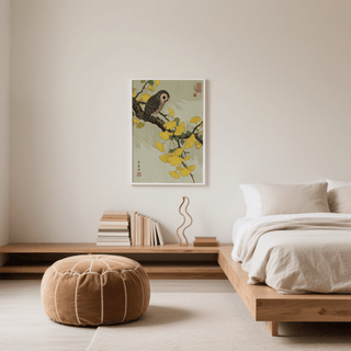 Owl and Ginkgo Print wall art with yellow leaves and owl above books on a wooden ledge