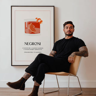 Framed Negroni Cocktail Poster with minimalist illustration in red and orange tones next to a seated man