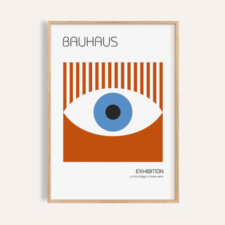 Framed print of a stylized eye graphic in blue and rust red with Bauhaus text