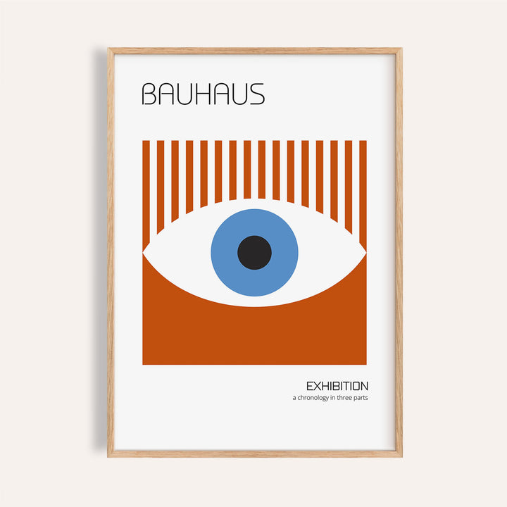 Framed print of a stylized eye graphic in blue and rust red with Bauhaus text