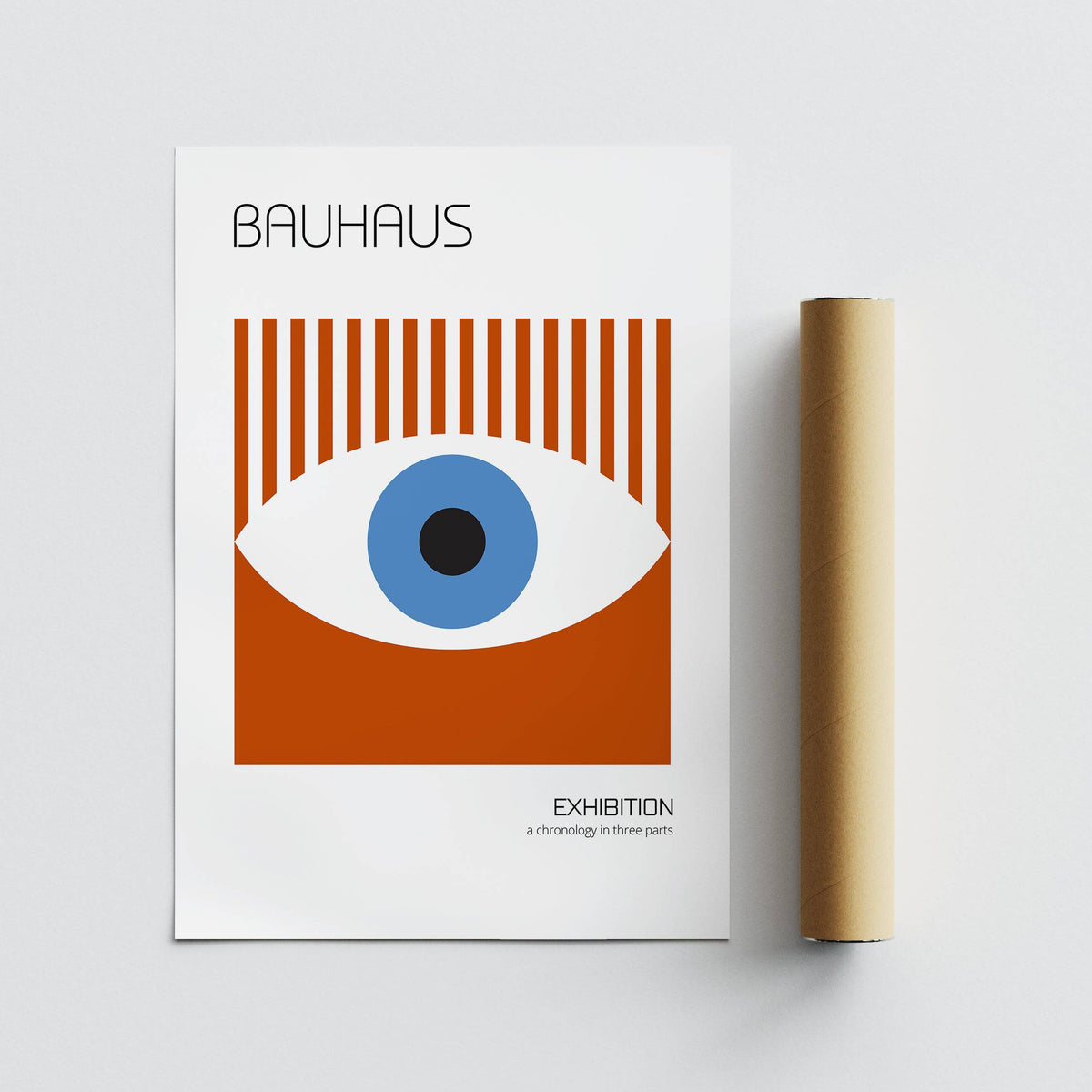 Bauhaus Posters minimalist eye graphic print with blue black and brown tones beside a brown packaging tube