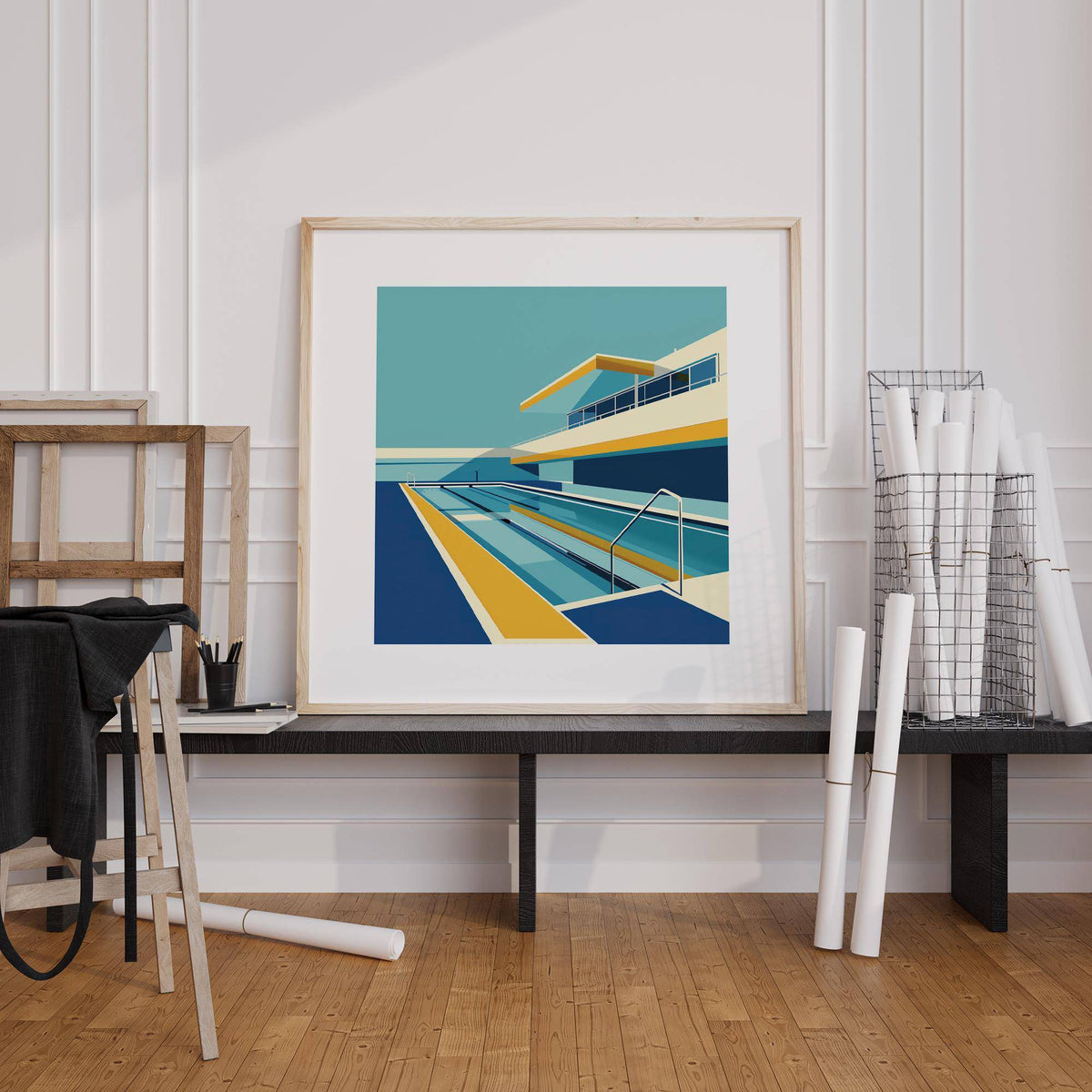 Poolside Art framed print with blue and yellow minimalist pool design leaning on a low black table in a white room