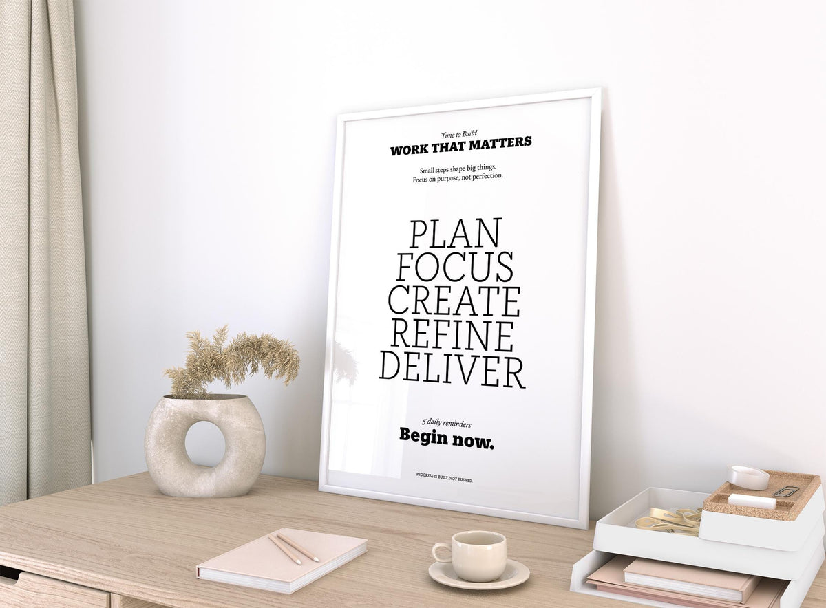 Motivate Quote Poster print leaning on a desk with neutral colours and a beige decorative vase nearby