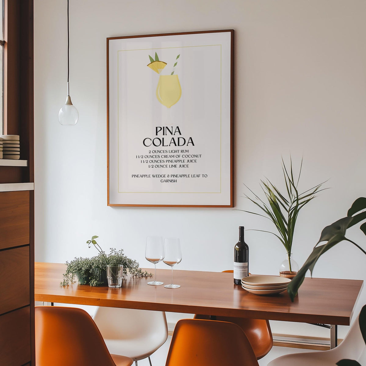 Wall Pictures for Kitchen print of a pina colada cocktail with yellow and green details above a wooden dining table