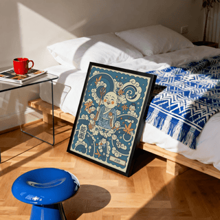 Print leaning on the floor of jizo art with blue and orange ink style near a bed and a blue stool