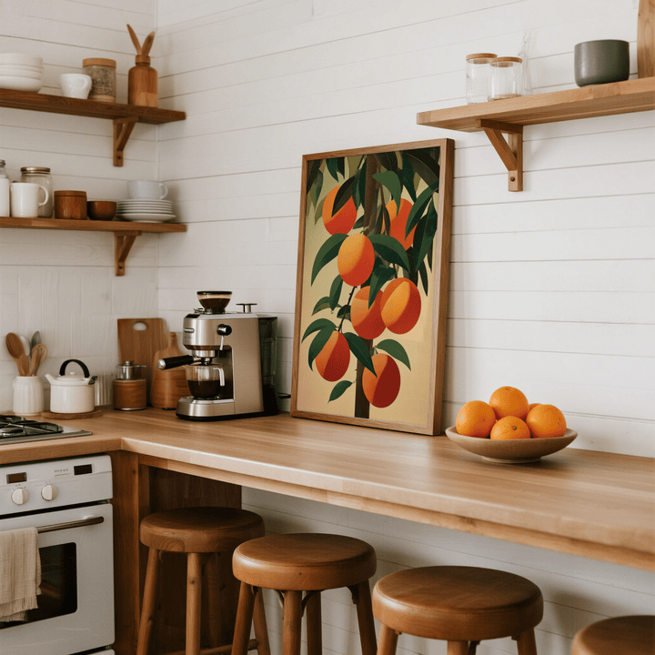 Print leaning on a kitchen counter showing a minimalist illustration of orange fruit bunch with green leaves and wooden frame next to