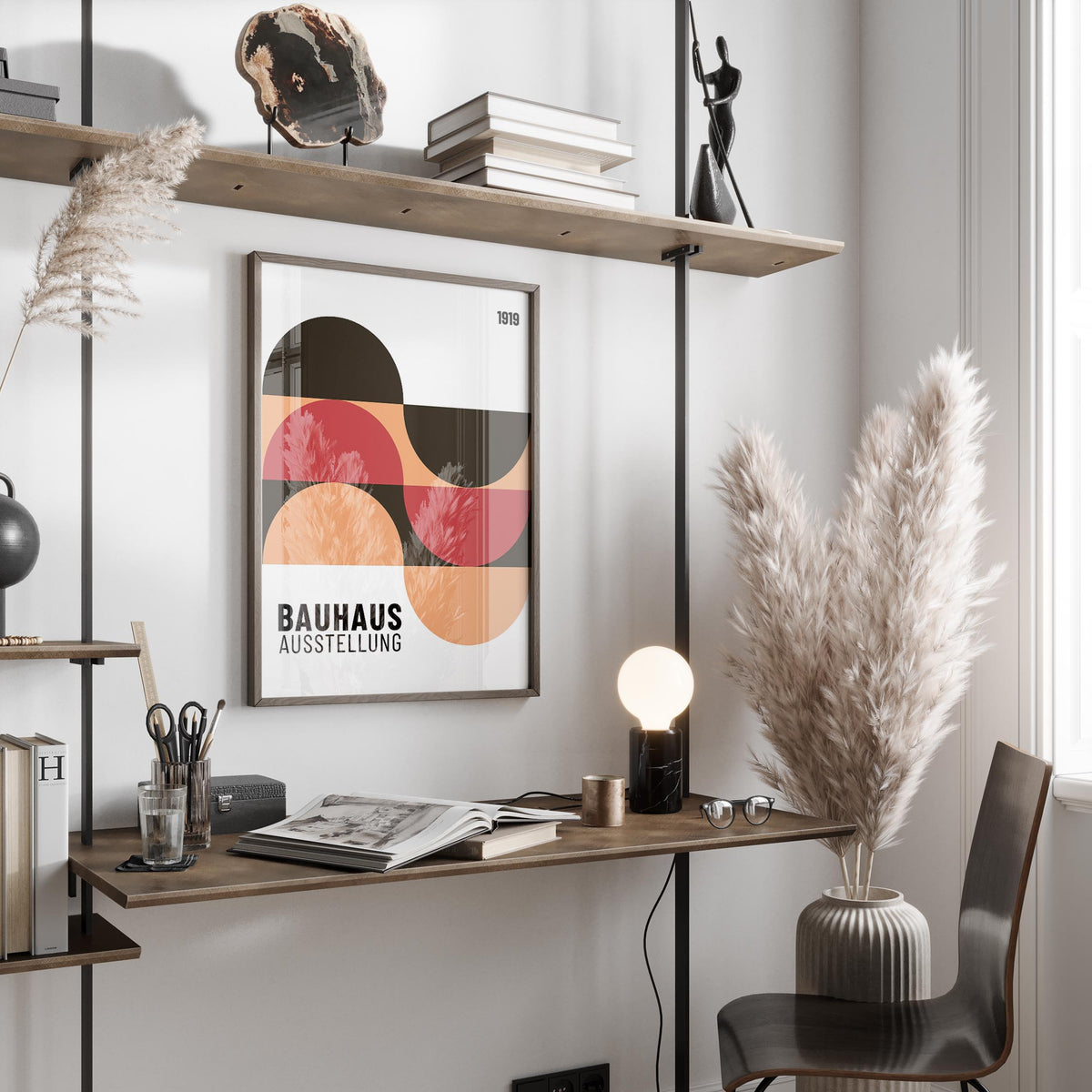Print on a wall in a home office with abstract geometric shapes in red brown and peach and a wooden shelf above