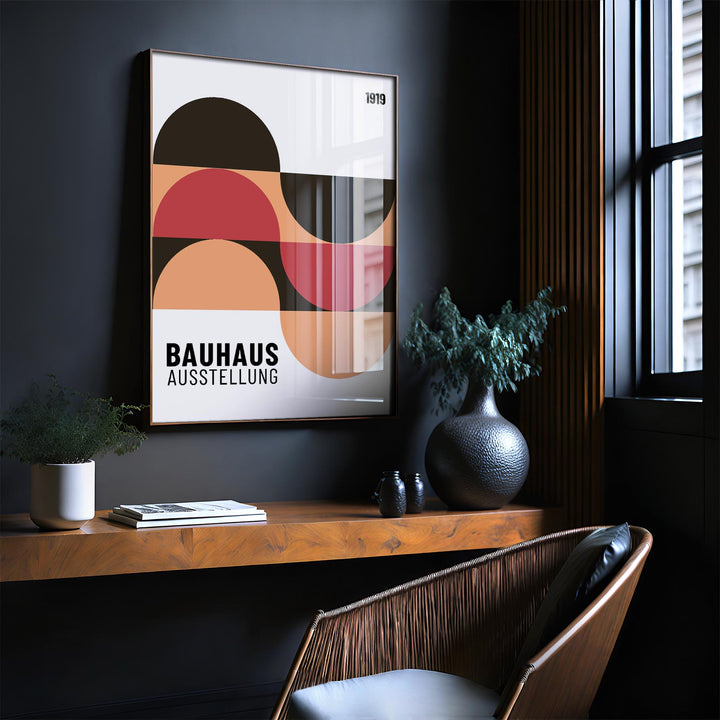 Home Office wall art with abstract geometric shapes in red, peach and black above a wooden shelf with plants