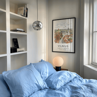 Vilnius City Print framed on a bedroom wall above a bedside table with a lamp