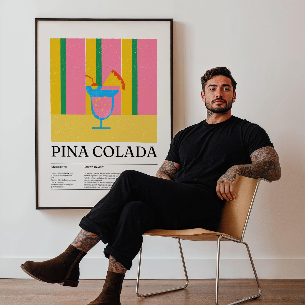 Framed print of piña colada wall art with yellow pink and green stripes behind a man sitting on a chair