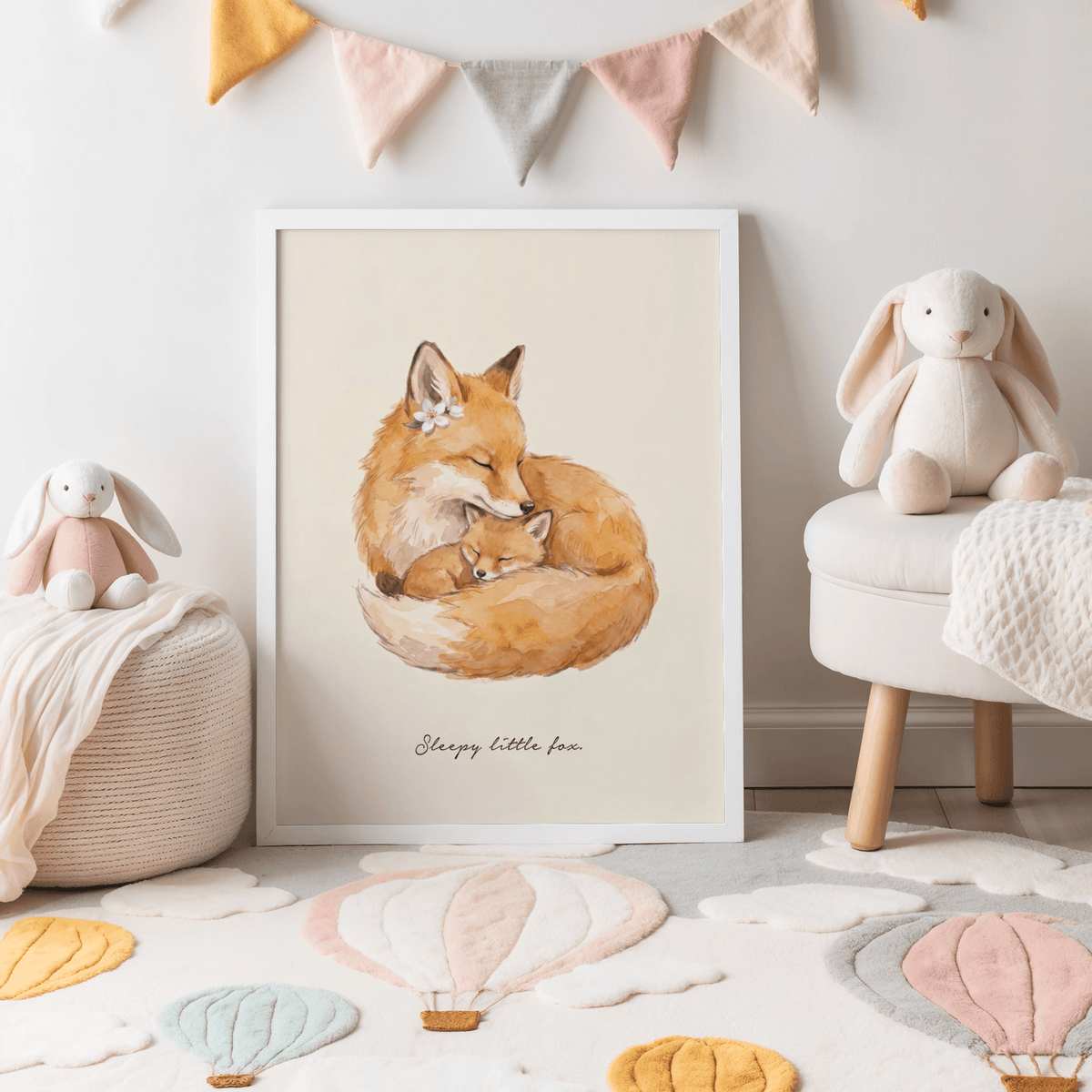 Sleepy Fox Art Print leaning on the floor with pastel bunting and soft toys in a child's room