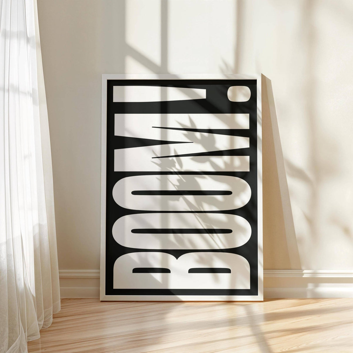 Modern Typography wall art with bold white letters on black leaning on floor beside sheer curtain with shadows on wall