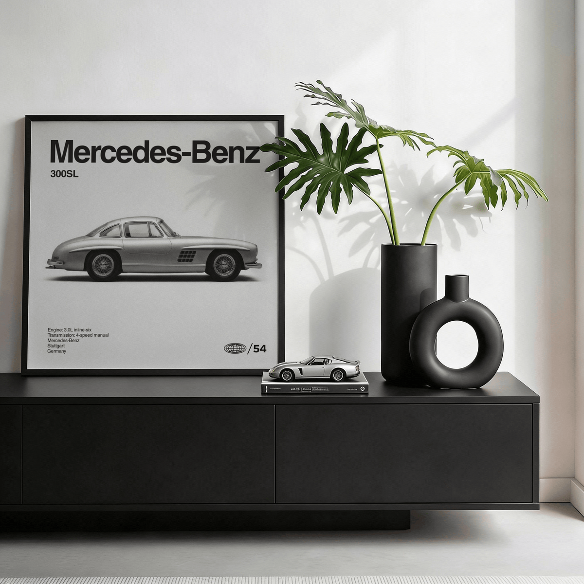 Classic Gullwing Sports Car Poster framed print with a monochrome car image next to black modern vases on a sideboard