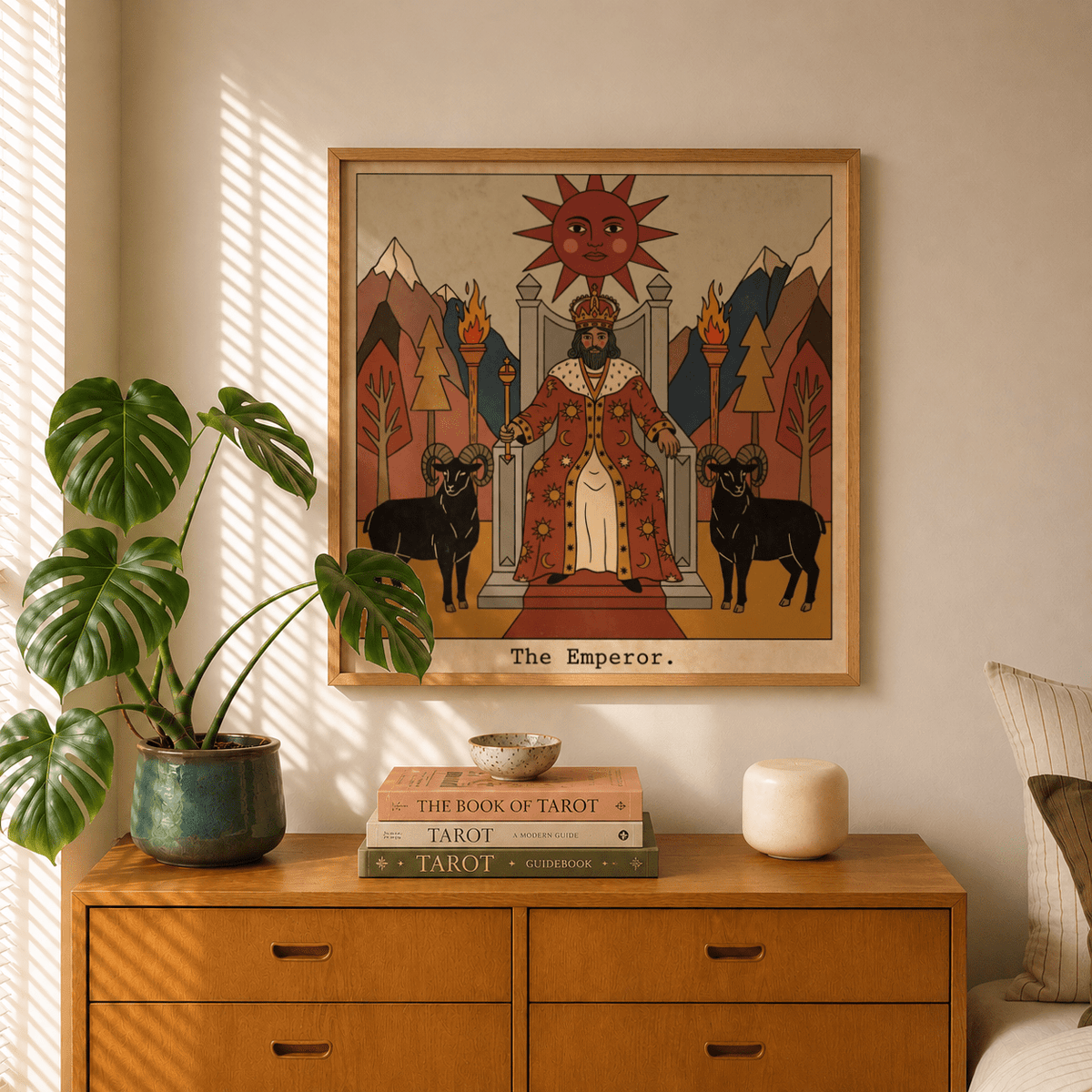 The Emperor Tarot Card Art print on a wall with plants and books on a wooden dresser