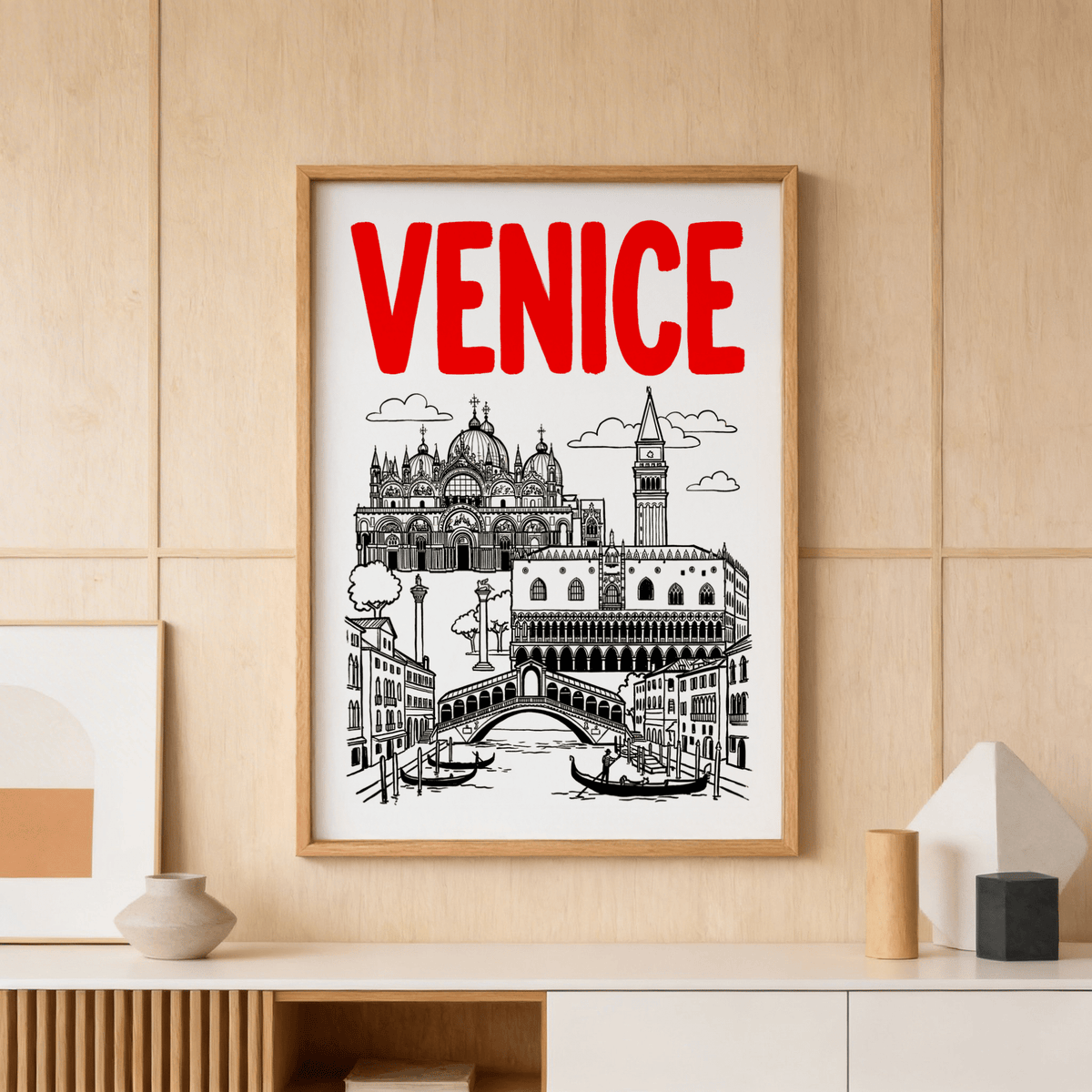 Framed Venice Landmark Art Print in black red and white on a wood panel wall above a console
