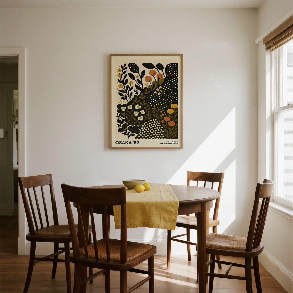 Daisy art print with orange and yellow flowers in a dining room above a wooden table with chairs