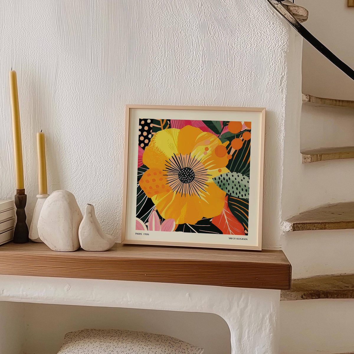 Yellow Flower Art print leaning on a wooden shelf next to candles and pottery in a neutral room