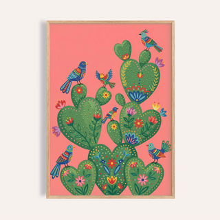 Framed print of colorful cactus art print with decorated green cactus and bright birds on coral background