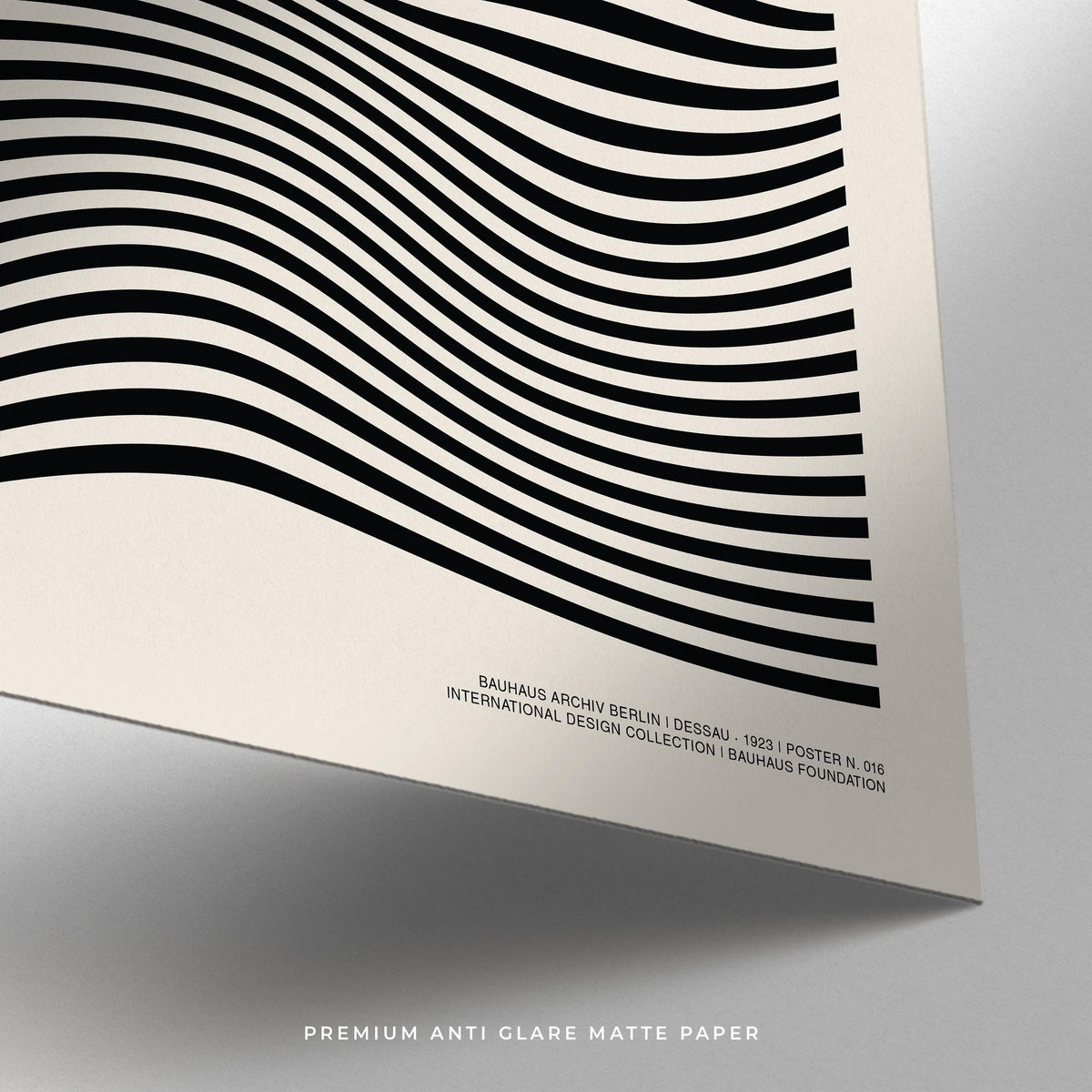 Detail close-up of sage green print showing black wavy lines on matte paper