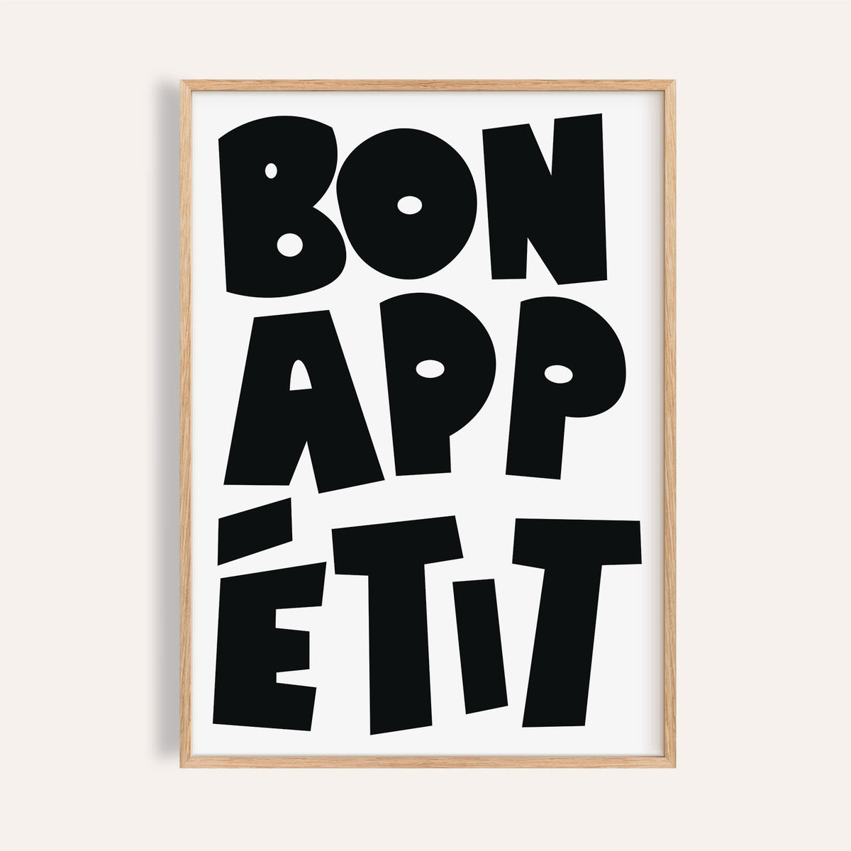 Framed close-up of French art prints with black bold typographic text saying Bon Appétit on white background