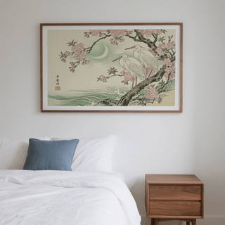 Heron wall art of white herons and pink cherry blossoms above a wooden bedside cabinet