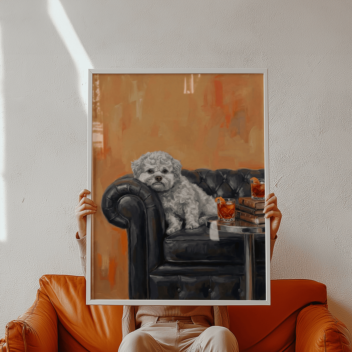 Framed print of a dog with human face on a black sofa with drinks and books held by person on brown sofa