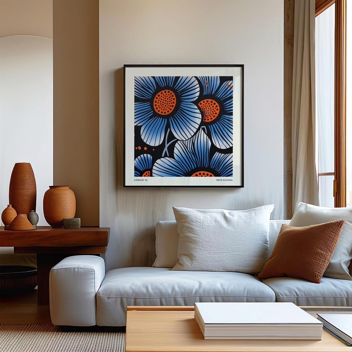 Blue flower wall art in pop art style with blue and orange details above a white sofa
