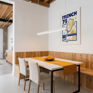 Print on a wall in a dining room of a French 75 Poster with blue and yellow minimalist illustration