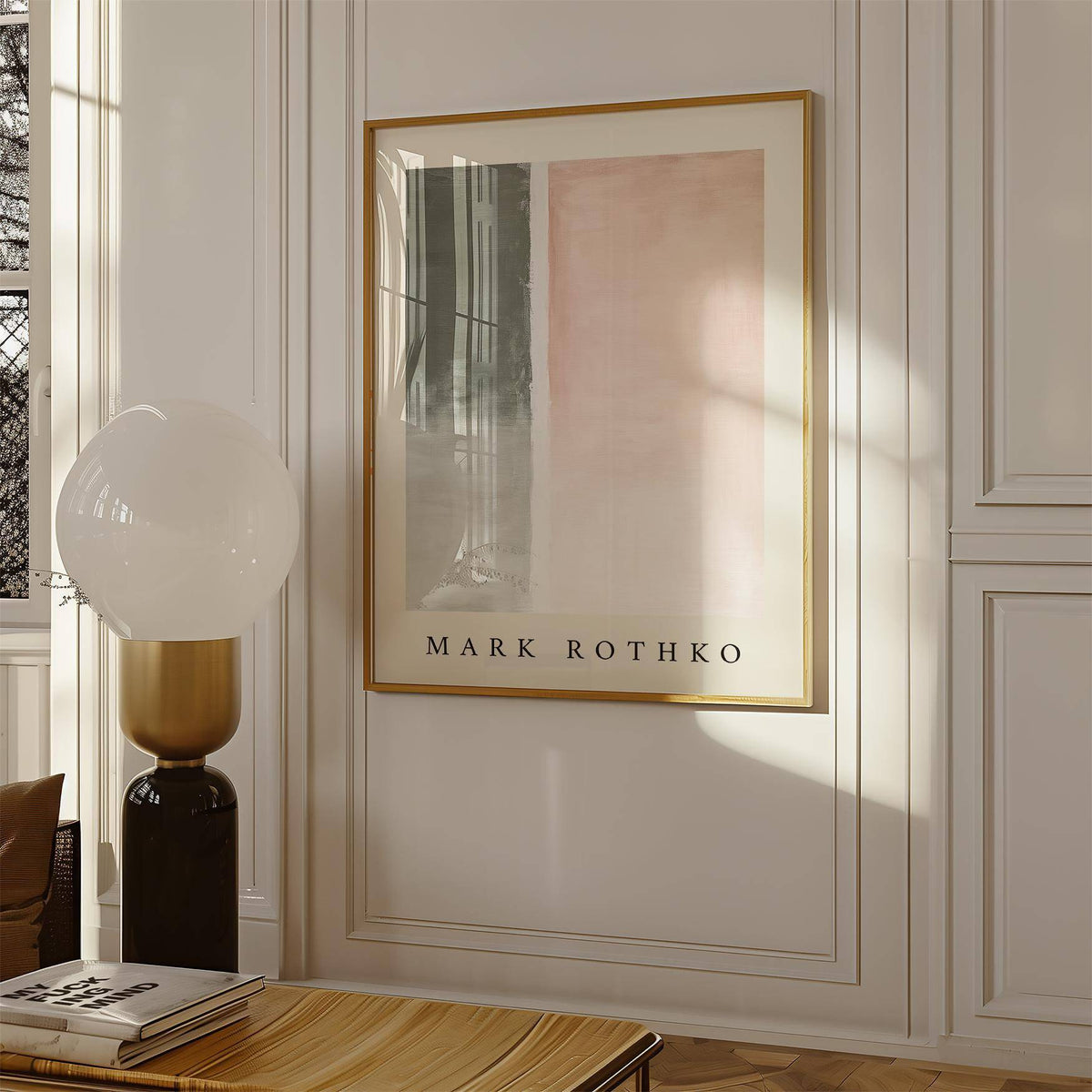 Art wall painting with abstract pastel blocks in a gold frame on a white paneled wall with a modern lamp nearby