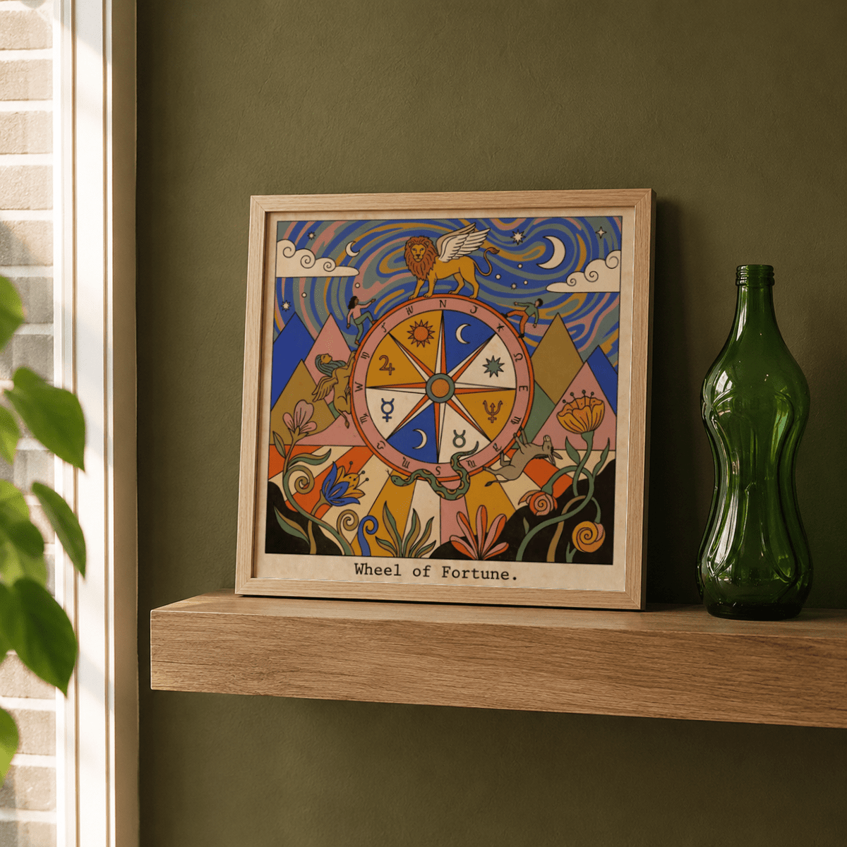 Framed Wheel Of Fortune Tarot Card Art print with folk-art style and colourful swirls on a wooden shelf