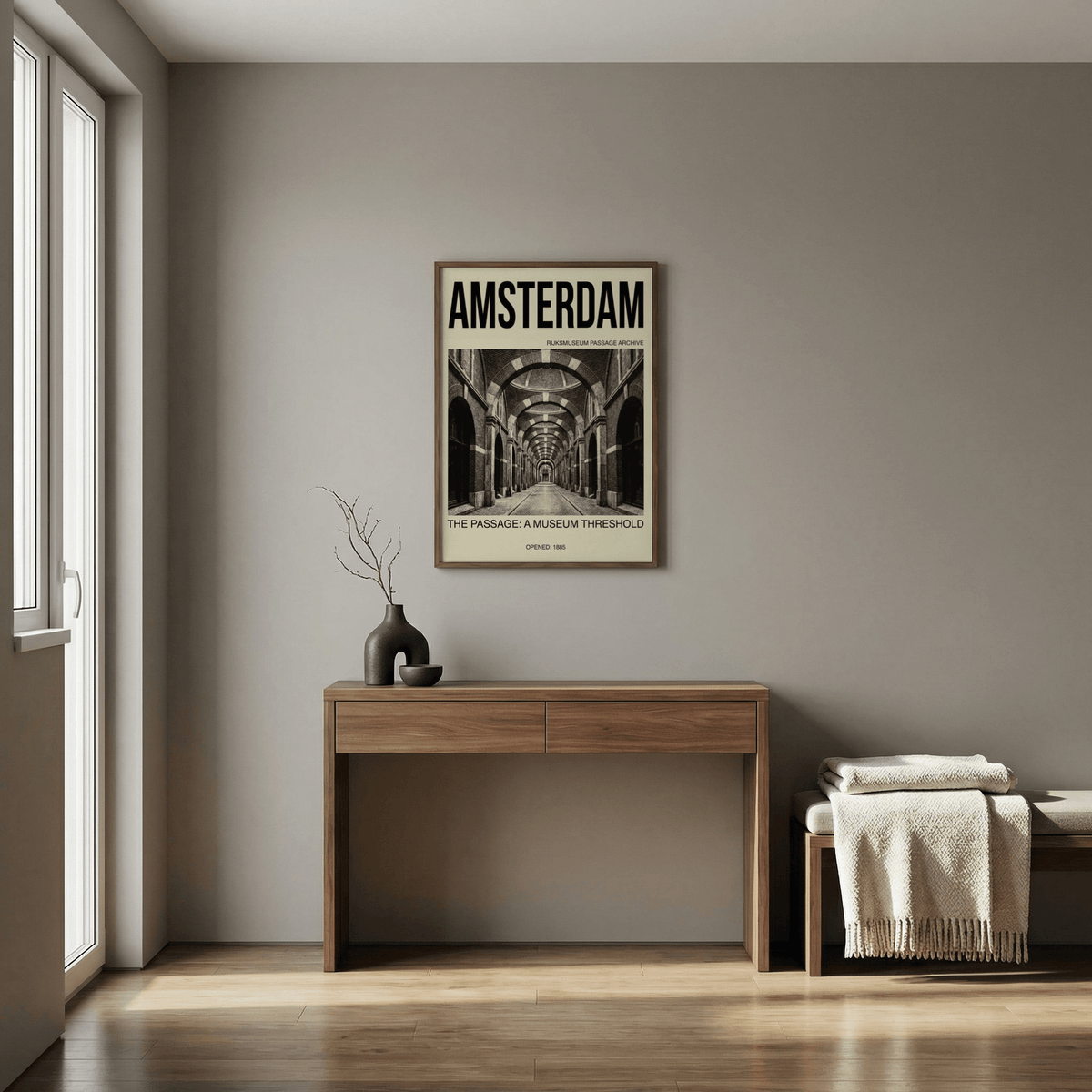 Amsterdam Passage wall art in black and cream above a wooden desk with a vase and twigs in a neutral hallway