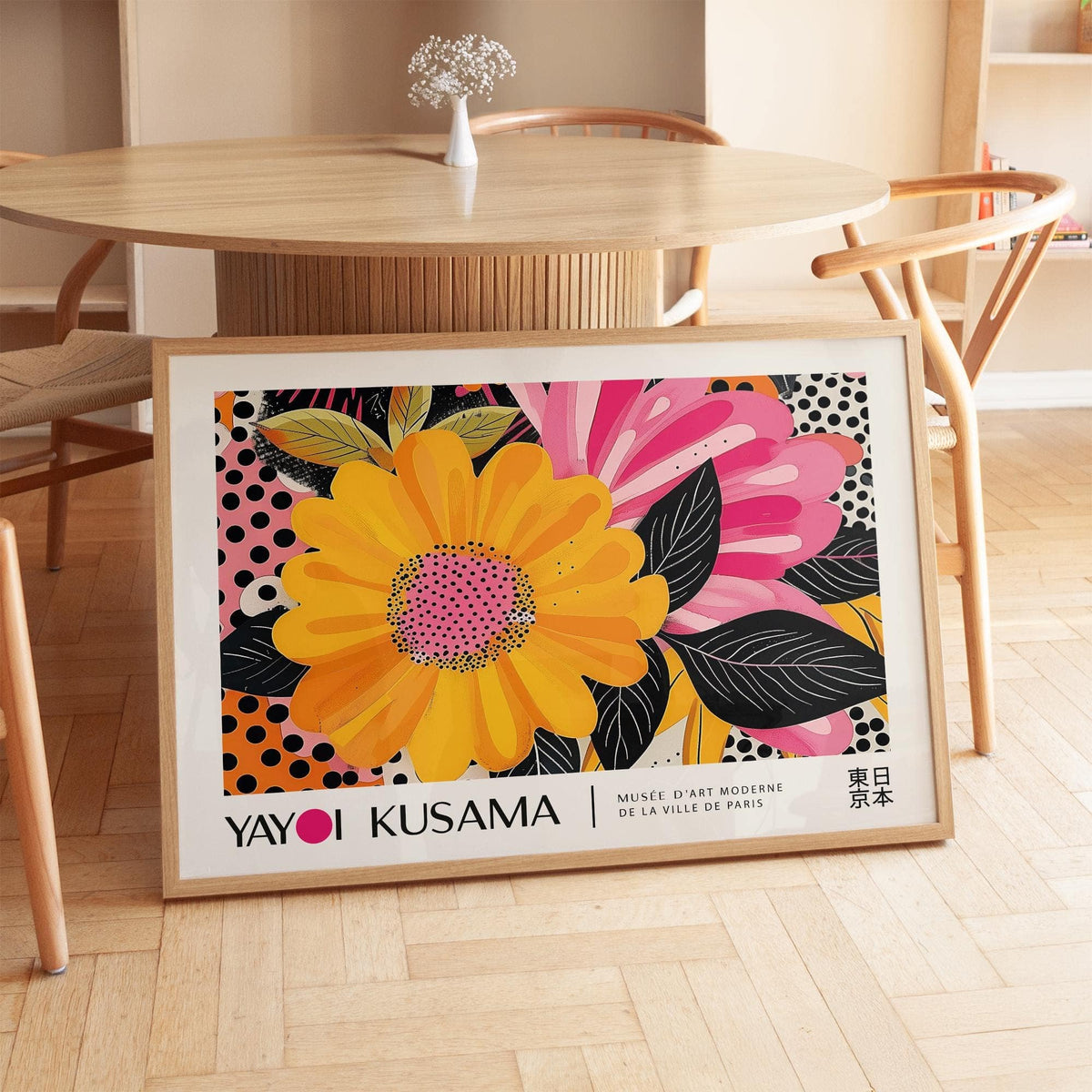 Floral Landscape Paintings print with bold yellow flower and pink petals leaning on wooden floor near table