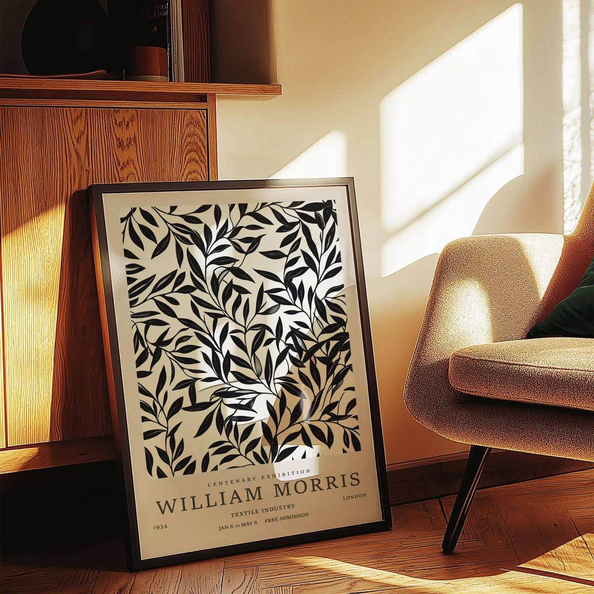 Print leaning on a shelf with black leaf branches on an off-white background in natural sunlight