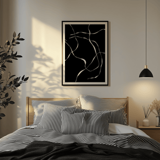 Abstract Lines art print with white abstract lines on black above a bed with striped pillows