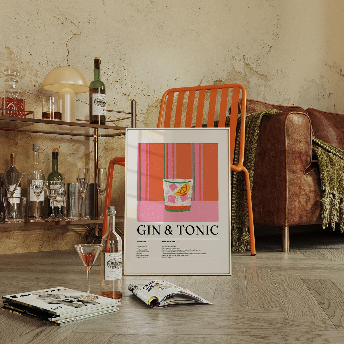 Print leaning on the floor of a gin and tonic minimalist illustration with pink and orange stripes near an orange chair and brown sofa