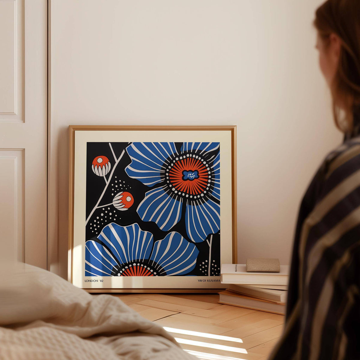 Flowers Prints leaning print of blue poppy flowers with orange centres beside stacked books