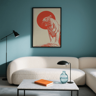 Bold Tiger wall art of a roaring tiger with a red circle behind displayed above a white sofa in a lounge