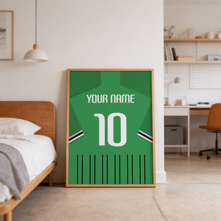Football Shirt Poster in Green with Black and White Sleeve Stripes leaning on the floor by a wooden bed in a bedroom