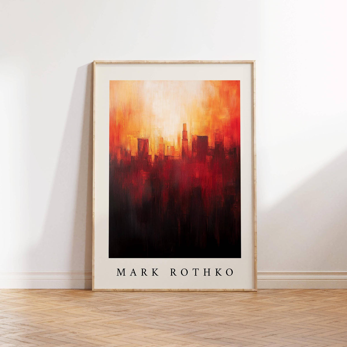Framed California wall art of a city skyline in red orange and black leaning on a wooden floor