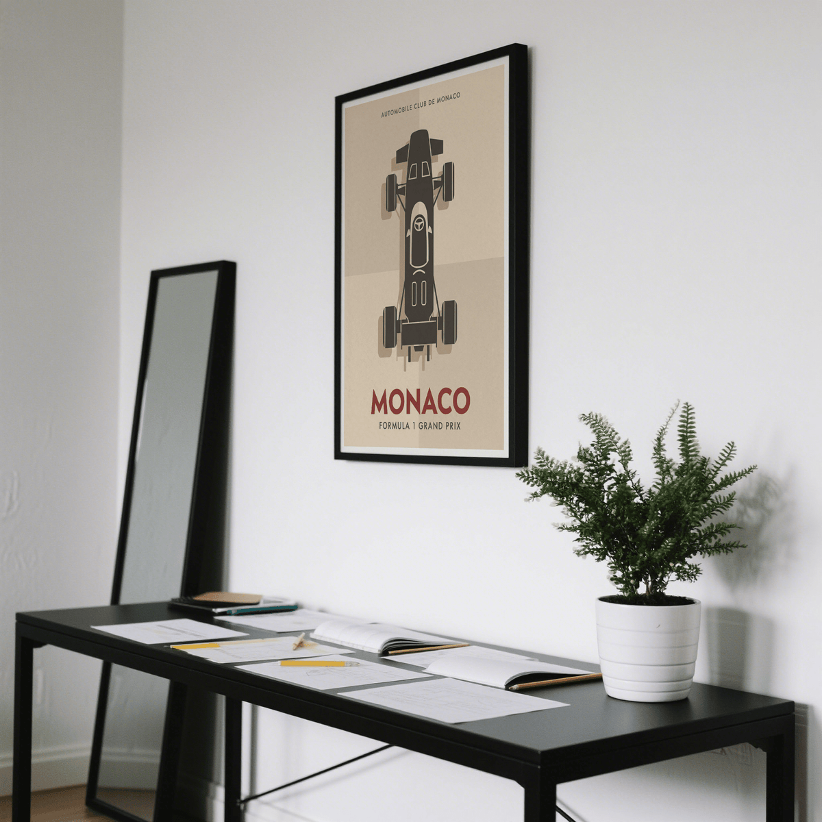Top-Down Racing Car Poster print on a wall in an office with a black desk and a potted fern
