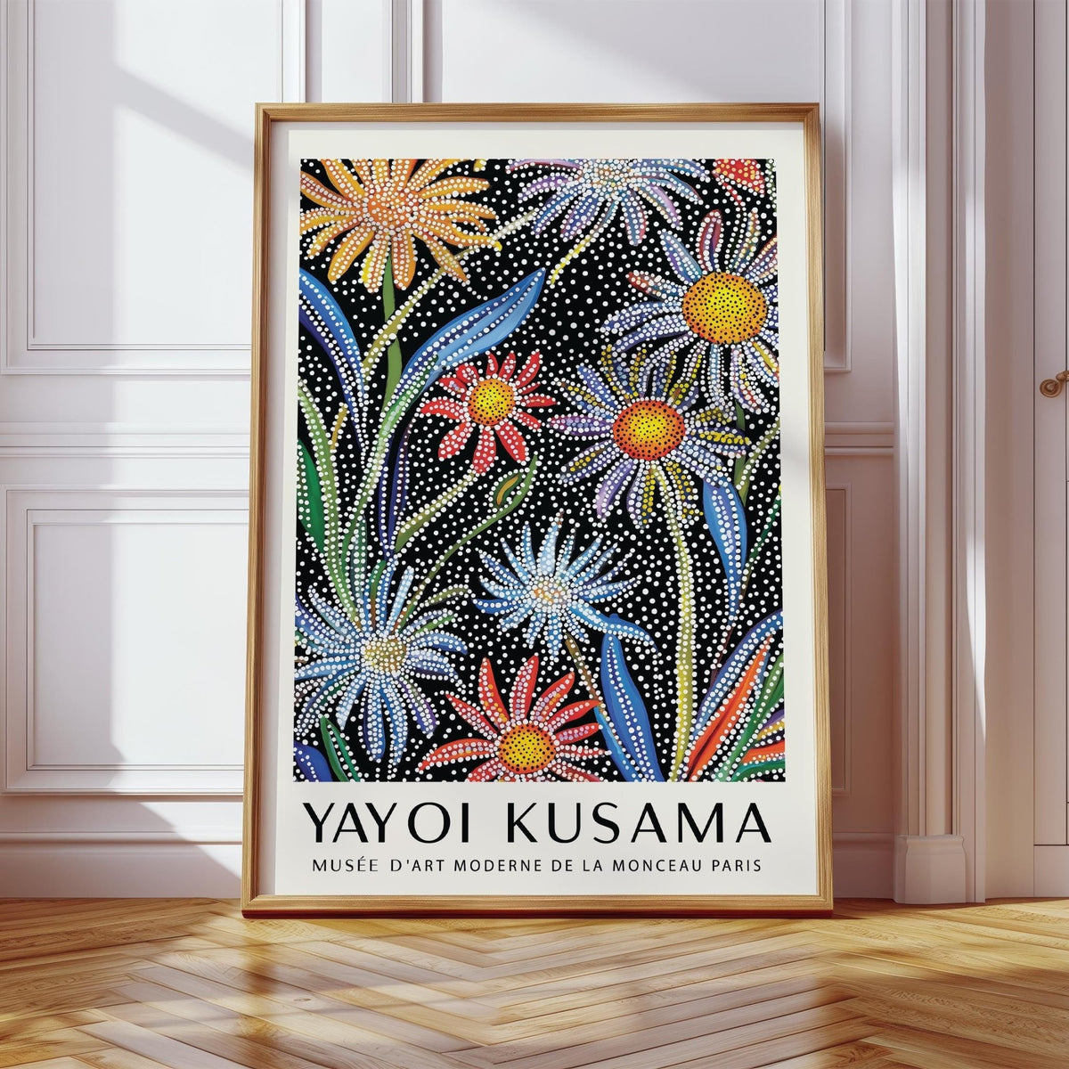 Framed floral pop art print of daisies with dot pattern leaning on a floor