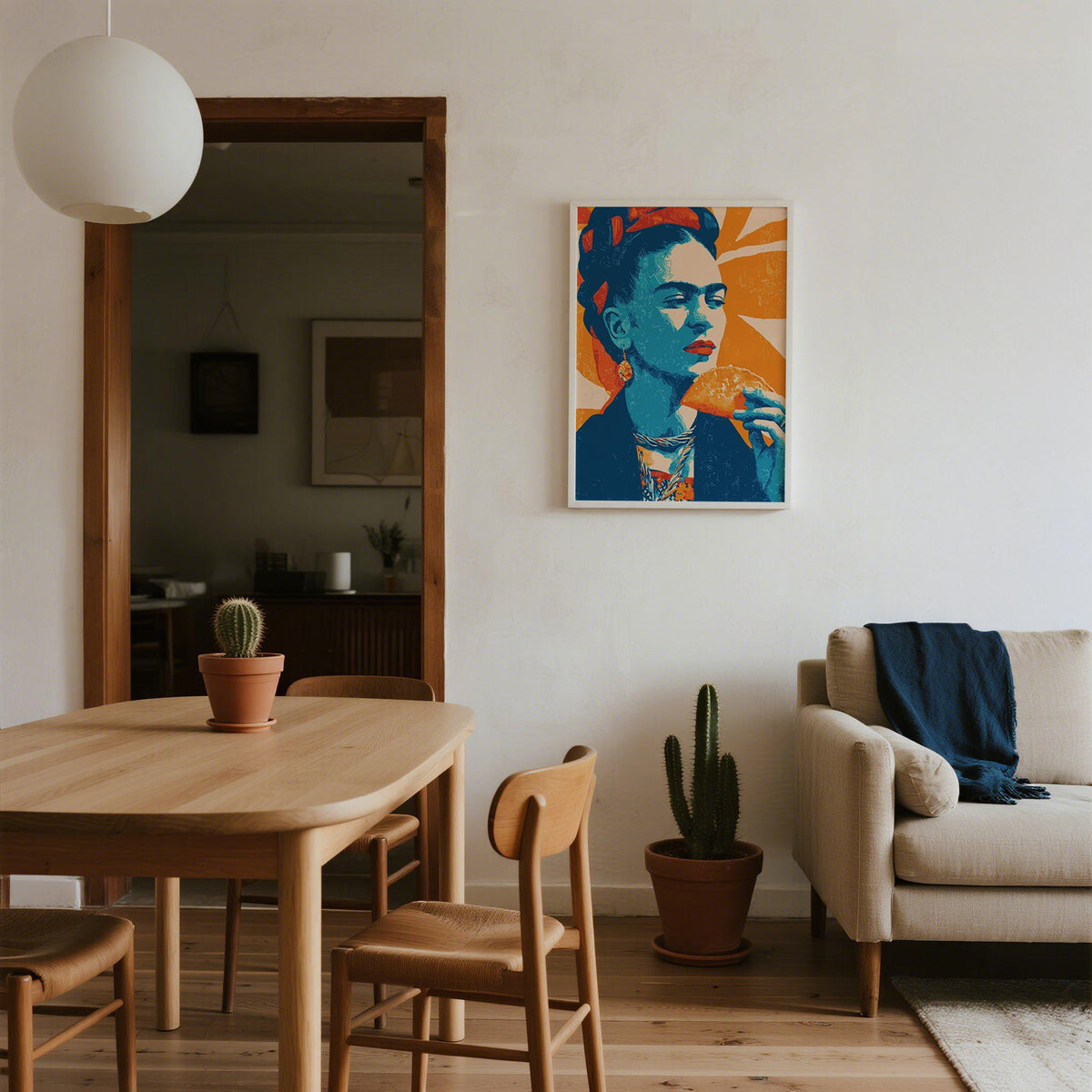 Taco print of a woman eating a taco in blue and orange hung on a living room wall near a cactus