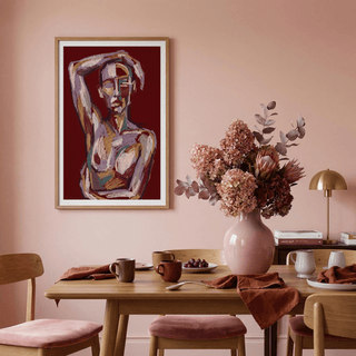 Contemporary Figure Art print of an abstract human figure in purple and brown tones above a dining table with a pink vase and flowers