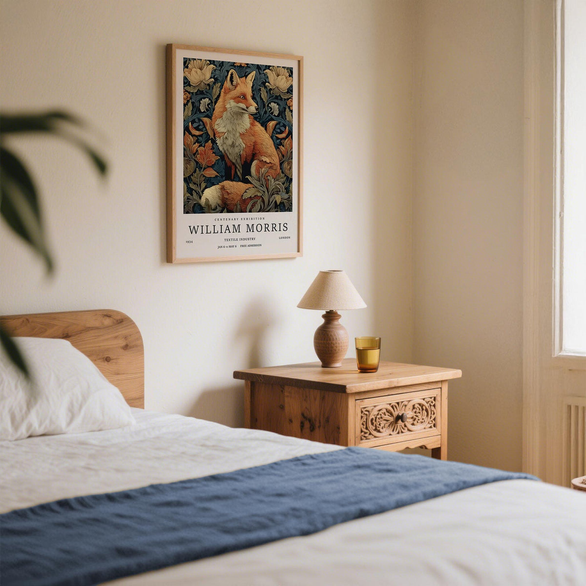 William Morris Fox Print framed print of a red fox and floral patterns in a bedroom above a carved wooden bedside table