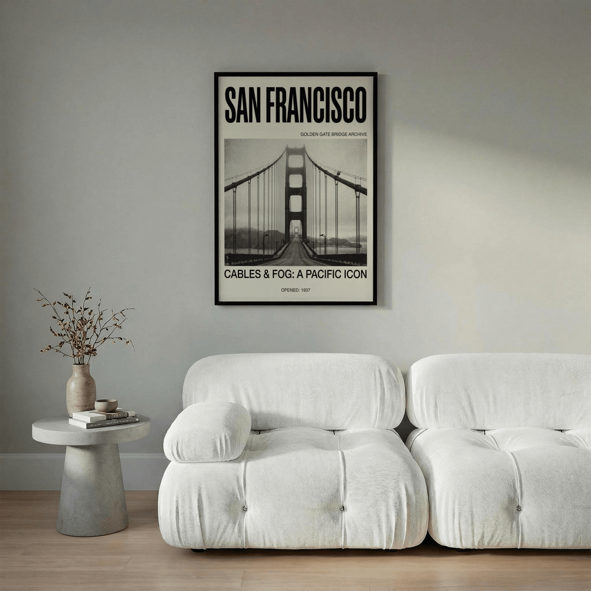 Golden Gate Bridge Art Print above a white sofa with a grey wall and side table with vase