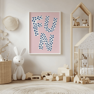 Fun typography wall art with blue polka dot letters on pink above toys in a nursery